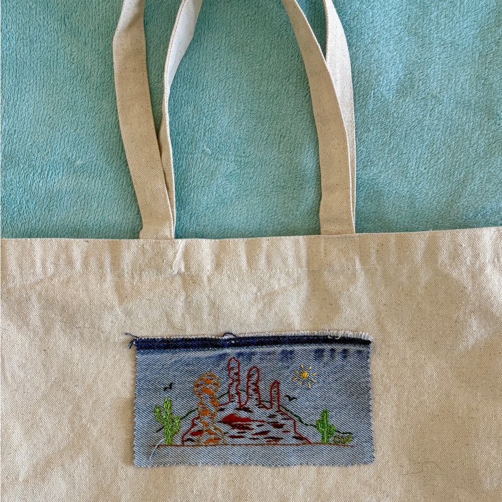 Hand Embroidered desert scene Patch on denim.